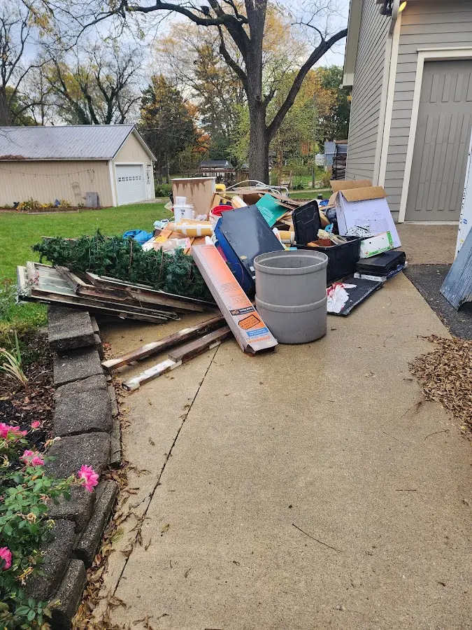 Dumpster being loaded with debris for Roofing Dumpster Rental in Hopkinton